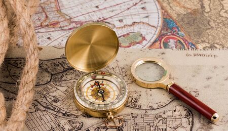 compass and magnifying glass lie on the topographic mapの写真素材