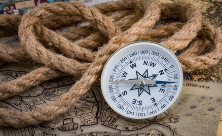 compass lies on an ancient world mapの写真素材