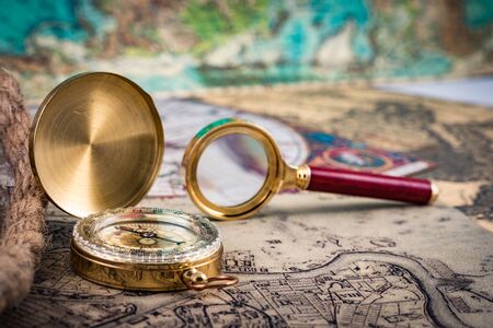 compass and magnifying glass lie on the topographic mapの写真素材