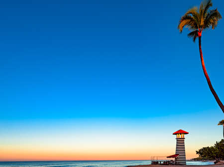 a striped high lighthouse stands on the shores of the Caribbean Dominican Republic for the safety of shipsの写真素材