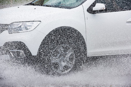 motion car rain big puddle of water spray from the wheels