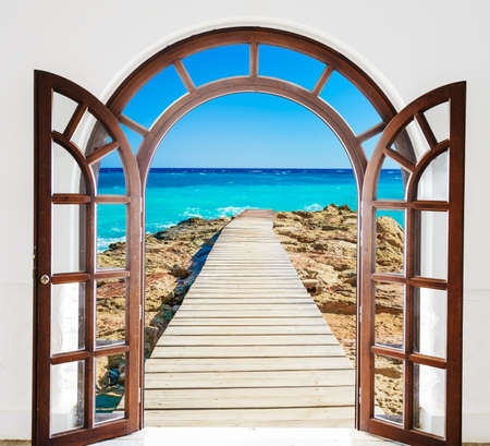 the view from the open window on the sea with a quayの写真素材