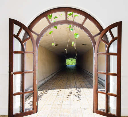 open wooden door arch entrance to the tunnelの写真素材