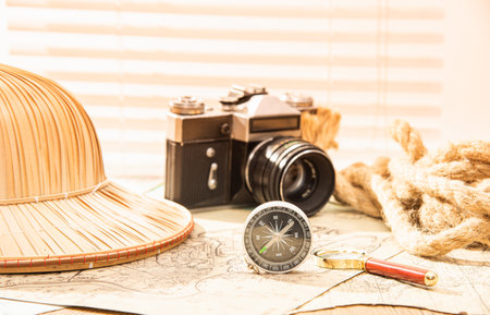 perdmet on the table for travel hat camera compass and magnifying glassの写真素材