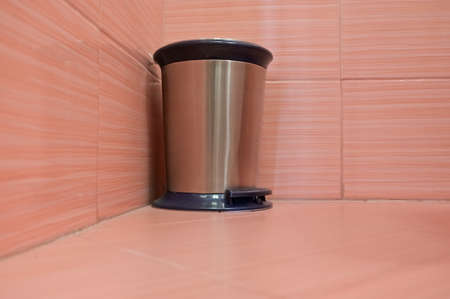 stainless steel trash can with lid and pedal in pink tiled restroomの写真素材
