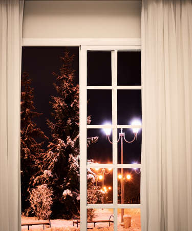 view from the window frosty winter night about the treeの写真素材