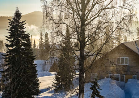 sunrise in the village on a frosty snowy morningの写真素材
