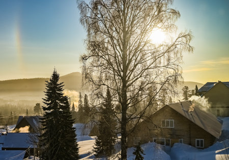 sunrise in the village on a frosty snowy morningの写真素材