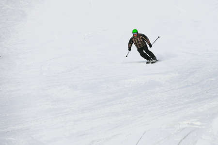 Russia. Sheregesh. 14 February 2021 skier riding down the huge snowfield splashing powder snow.のeditorial素材
