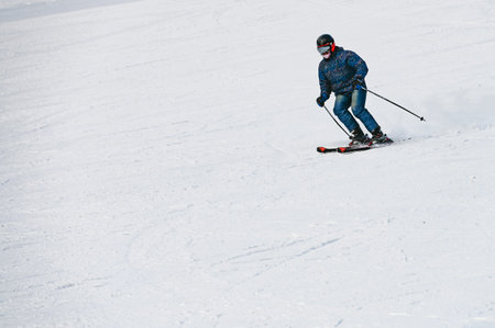 Russia. Sheregesh. 14 February 2021 skier riding down the huge snowfield splashing powder snow.のeditorial素材