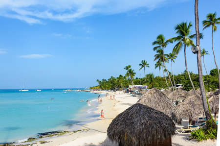 Caribbean coast tropical sandy beach with sun loungersの写真素材