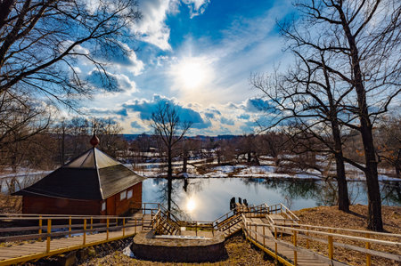 wooden bridge to the reservoir on a spring day in the water the reflection of the sunの写真素材