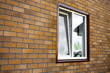 wall of the house trim with soft tiles with a windowの写真素材