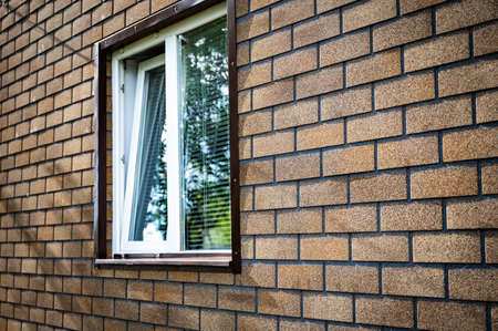 wall of the house trim with soft tiles with a windowの写真素材