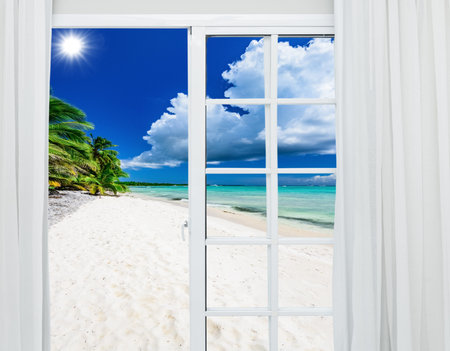 white glass door open overlooking tropical beach