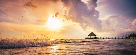beautiful view of the sea sunset caribbean sea in the dominican republic a pier with a gazeboの写真素材
