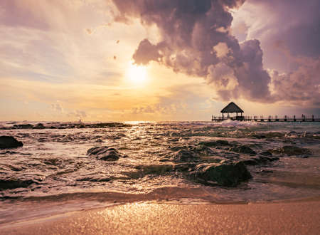 beautiful view of the sea sunset caribbean sea in the dominican republic a pier with a gazeboの写真素材