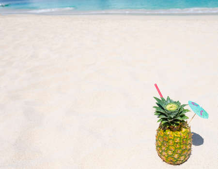 cocktail pina colada in pineapple on the sand of the caribbean beach in the Dominican republicの写真素材
