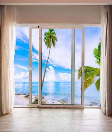 large glass door in the room overlooking the paradise beachの写真素材
