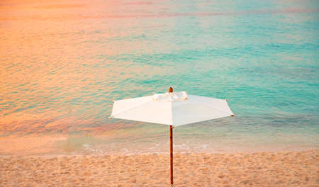 Paradise sandy beach on the Caribbean Sea with sun lounger and parasolの写真素材