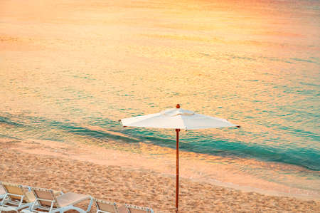 Paradise sandy beach on the Caribbean Sea with sun lounger and parasolの写真素材