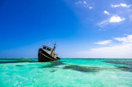 old abandoned naval boat aground in the caribbean seaの写真素材