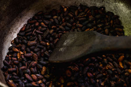 preparation of roasting coffee beans in the traditional way by hand over a fire in a cauldronの写真素材