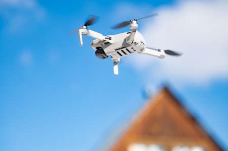 quadrocopter in flight against the blue skyの写真素材