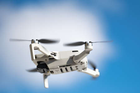 quadrocopter in flight against the blue skyの写真素材