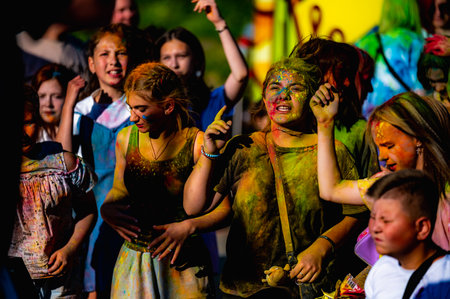 Russia, Chekhov, July 2, 2022. Cheerful youth holiday Holi spilling colorful paintsのeditorial素材