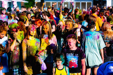 Russia, Chekhov, July 2, 2022. Cheerful youth holiday Holi spilling colorful paintsのeditorial素材