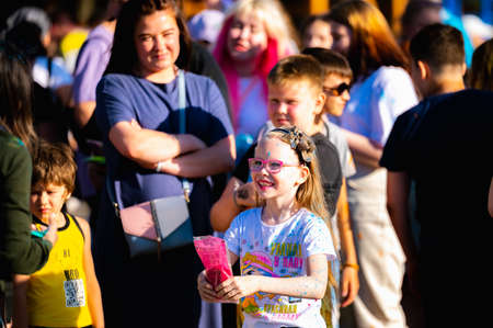 Russia, Chekhov, July 2, 2022. Cheerful youth holiday Holi spilling colorful paintsのeditorial素材