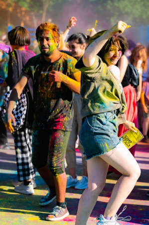 Russia, Chekhov, July 2, 2022. Cheerful youth holiday Holi spilling colorful paintsのeditorial素材