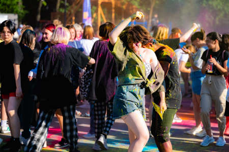 Russia, Chekhov, July 2, 2022. Cheerful youth holiday Holi spilling colorful paintsのeditorial素材