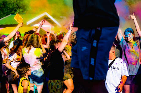 Russia, Chekhov, July 2, 2022. Cheerful youth holiday Holi spilling colorful paintsのeditorial素材