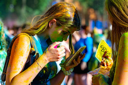 Russia, Chekhov, July 2, 2022. Cheerful youth holiday Holi spilling colorful paintsのeditorial素材