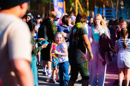Russia, Chekhov, July 2, 2022. Cheerful youth holiday Holi spilling colorful paintsのeditorial素材