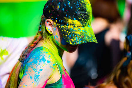 Russia, Chekhov, July 2, 2022. Cheerful youth holiday Holi spilling colorful paintsのeditorial素材