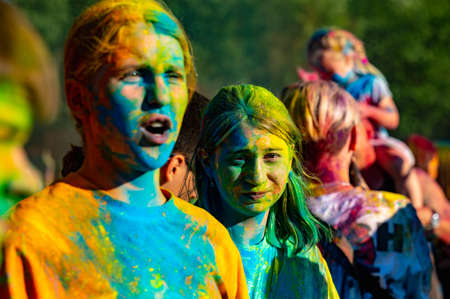 Russia, Chekhov, July 2, 2022. Cheerful youth holiday Holi spilling colorful paintsのeditorial素材