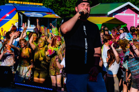 Russia, Chekhov, July 2, 2022. Cheerful youth holiday Holi spilling colorful paintsのeditorial素材