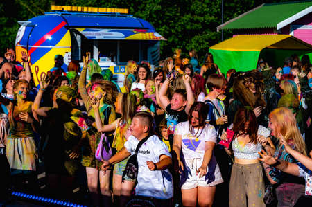Russia, Chekhov, July 2, 2022. Cheerful youth holiday Holi spilling colorful paintsのeditorial素材