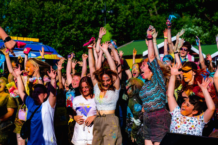 Russia, Chekhov, July 2, 2022. Cheerful youth holiday Holi spilling colorful paintsのeditorial素材