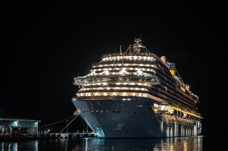 09/27/2022 Turkey, Kusadasi. big sea cruise liner at night illuminated by lights in the portのeditorial素材