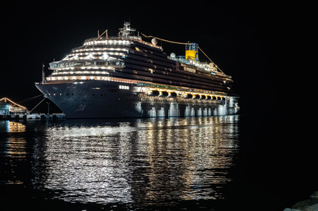 09/27/2022 Turkey, Kusadasi. big sea cruise liner at night illuminated by lights in the portのeditorial素材