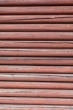 The image is of a wooden surface with many grooves and ridges. The wood appears to be old and weathered, giving the surface a rustic and natural feel. The texture of the wood is rough and unevenの写真素材