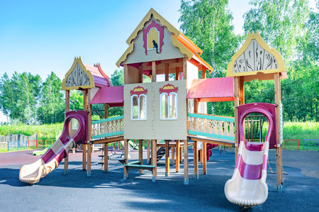 Vibrant children's playground featuring detailed play structures and spiral slides in a lush park setting. The colorful design invites imaginative play and exploration for children.の写真素材