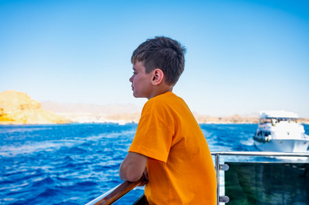 A boy on a yacht in the Red Sea is vacationing in Egypt.の写真素材