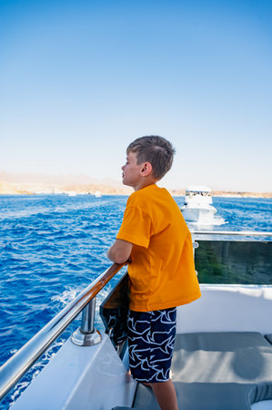 A boy on a yacht in the Red Sea is vacationing in Egypt.の写真素材
