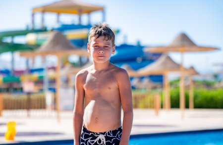 A boy in swimming trunks near a pool at a hotel in Egyptの写真素材