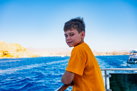 A boy on a yacht in the Red Sea is vacationing in Egypt.の写真素材
